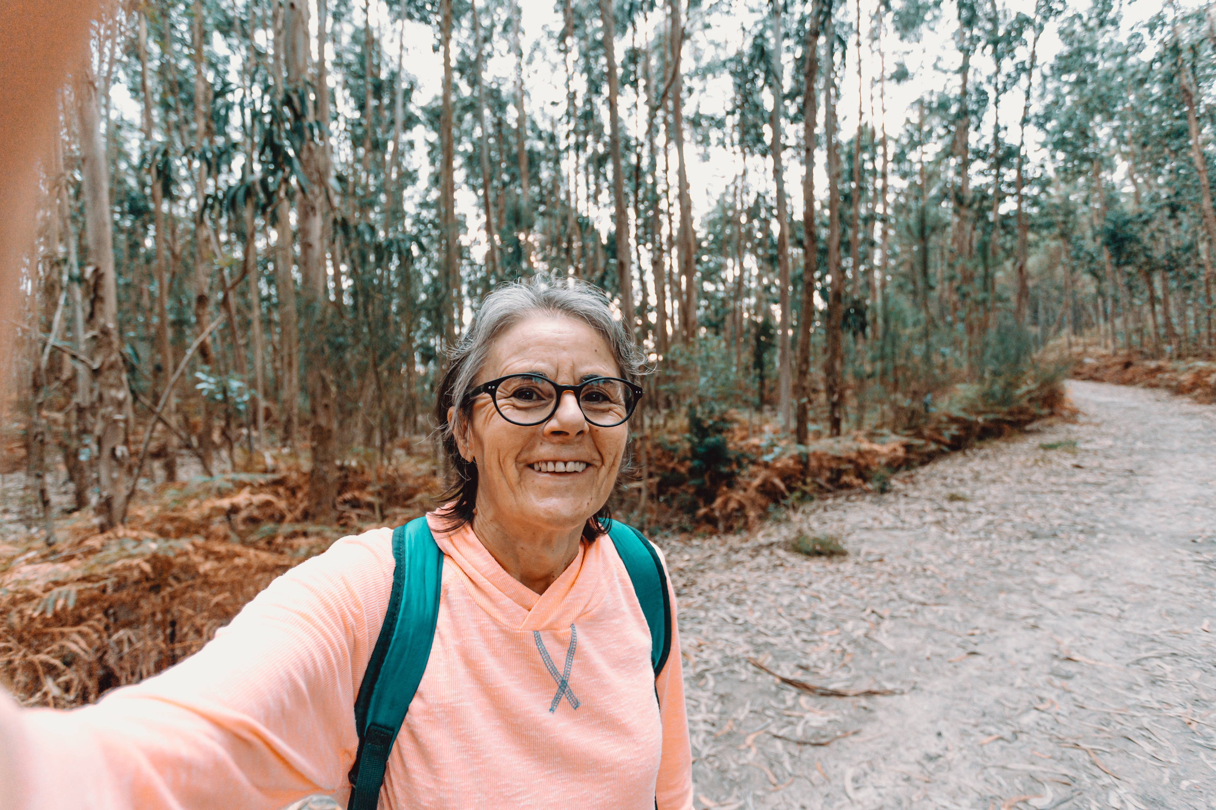 files/woman-smiles-and-takes-a-selfie-while-out-on-a-hike.jpg